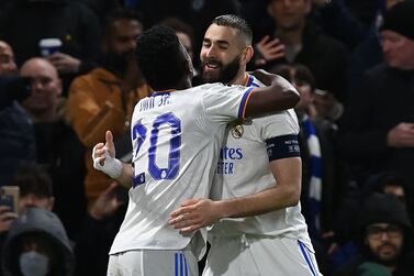 Real Madrid's French striker Karim Benzema (R) celebrates with Real Madrid's Brazilian striker Vinicius Junior (L) after scoring his third goal during the UEFA Champions League Quarter-final first leg football match between Chelsea and Real Madrid at Stamford Bridge stadium in London, on April 6, 2022.  (Photo by Glyn KIRK  /  IKIMAGES  /  AFP)