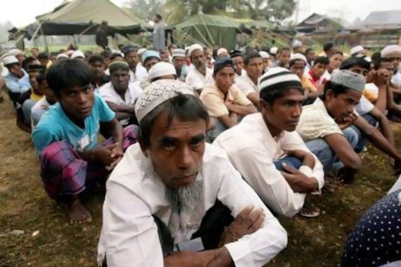 Rohingya boat people wait for their breakfast at a temporary shelter in the Idi Rayeuk district of Indonesia's Aceh province.