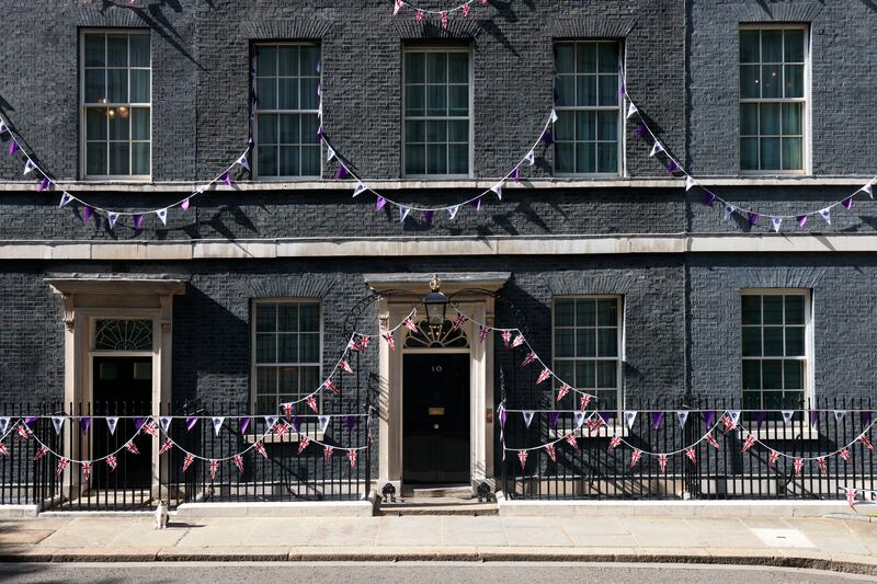 Larry the Cat, Chief Mouser to the Cabinet Office, sits outside Downing Street, London, adorned in bunting before the platinum jubilee celebrations, in London. AP