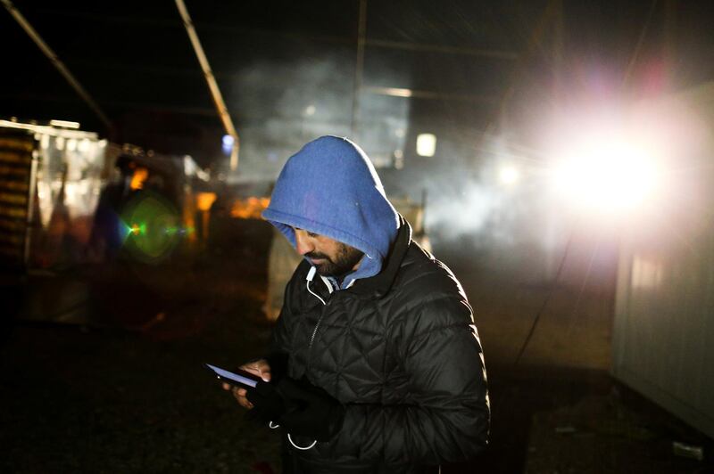 A man uses a mobile phone at the camp. Reuters