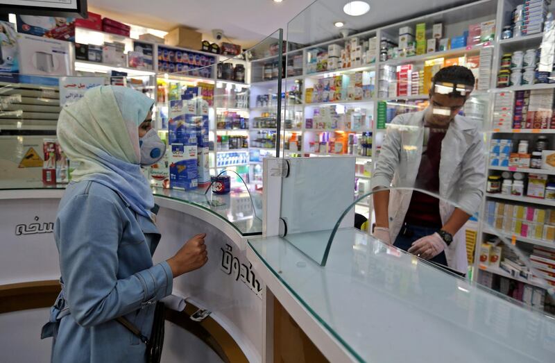 People wearing protective masks shop at a pharmacy in the Iranian capital Tehran on February 24, 2020. - Iran's government vowed on February 24 to be transparent after being accused of covering up the deadliest coronavirus COVID-19 outbreak outside China as it dismissed claims the toll could be as high as 50. The authorities in the Islamic republic have come under mounting public pressure since it took days for them to admit to "accidentally" shooting down a Ukrainian airliner last month, killing 176 people. Iran has been scrambling to contain the outbreak since it announced the first two deaths in the holy city of Qom on February 19. (Photo by ATTA KENARE / AFP)
