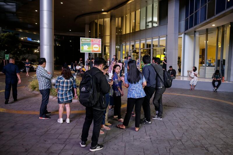 Residents stand outside of a highrise building following a 6.8-magnitude earthquake that hit Banten province, Indonesia.  EPA