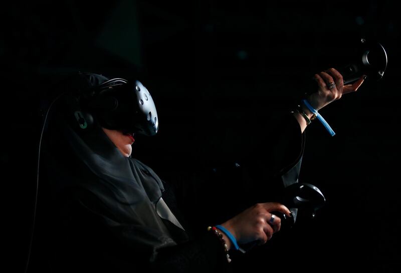 A female visitor uses VR to play tennis game during Dubai Artificial Intelligence in Sports (DAIS) Conference and Exhibition in Dubai.  EPA