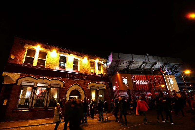 Fans gather outside Anfield before the Premier League match between Liverpool and Swansea City on Monday. Clive Brunskill / Getty Images