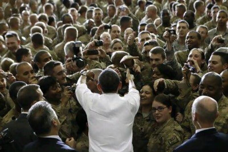 US President Barack Obama greets troops at Bagram Air Base in Kabul. Mr Obama and Hamid Karzai, the Afghan President, signed the Strategic Partnership Agreement at the Presidential Palace.