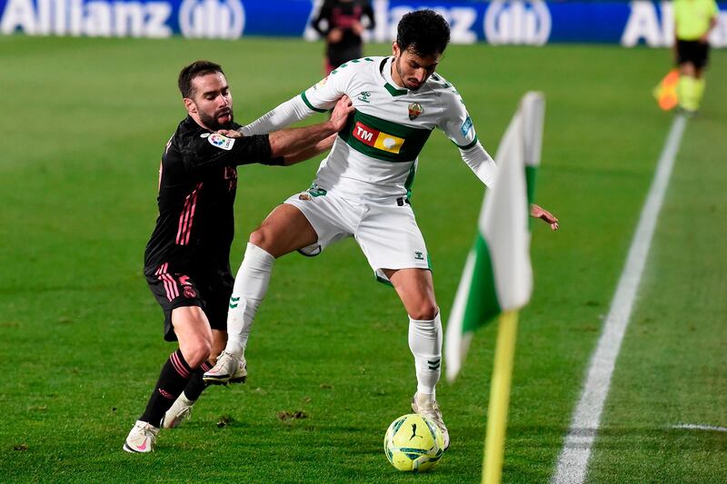 Real Madrid's Dani Carvajal challenges Elche's Juan Sanchez Mino. AFP