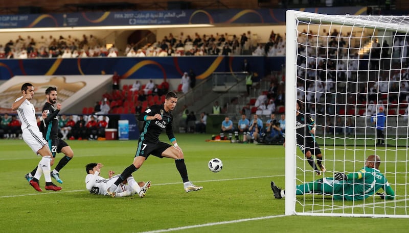 Real Madrid’s Cristiano Ronaldo in action with Al Jazira’s Ali Khaseif. Matthew Childs / Reuters