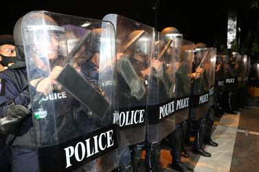 Thai policemen with riot shields stand during a demonstration in Bangkok, Thailand, Thursday, Oct. 15, 2020. Thai police dispersed a group of protesters holding an overnight rally outside the prime minister's office. (AP Photo/Rapeephat Sitichailapa)