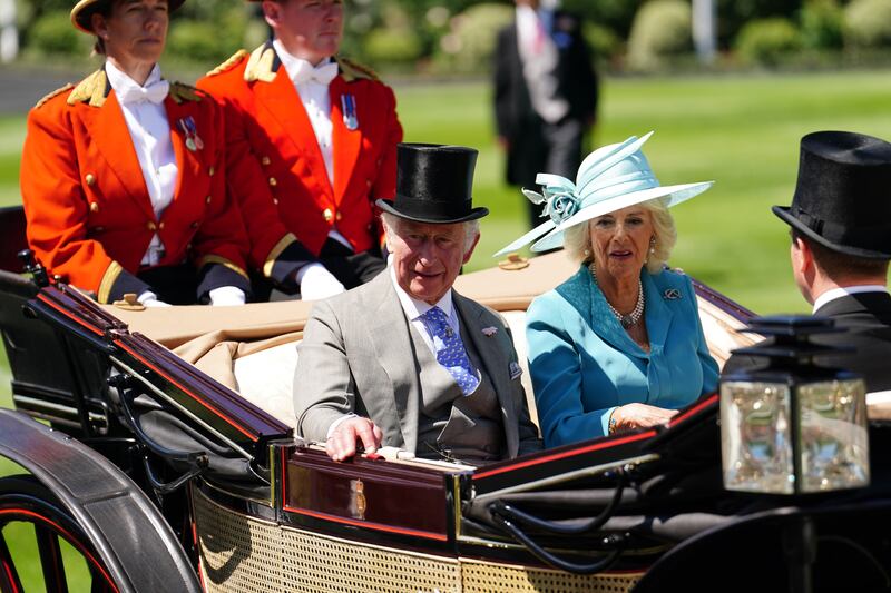 The Prince of Wales, the Duchess of Cornwall and Peter Phillips arriving by carriage during the royal procession. PA