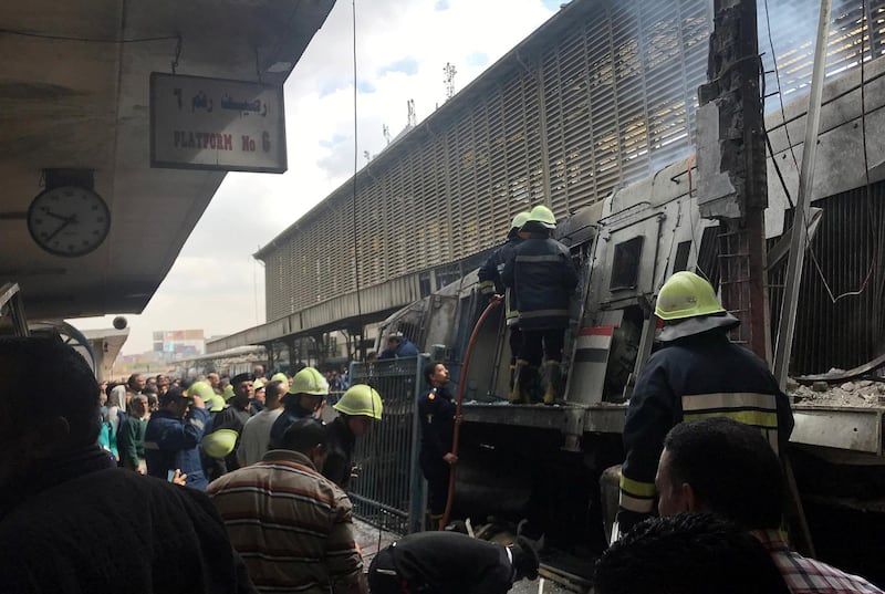 Rescue workers are seen after a fire at the main train station in Cairo. Reuters