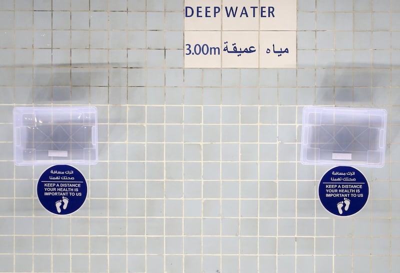 A signs showing social distancing regulations is seen at Hamdan Sports Complex. Getty Images