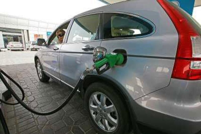 A motorist fills up at Adnoc, in Abu Dhabi: analysts surveyed say next year will see a worldwide rise in demand for petroleum products.