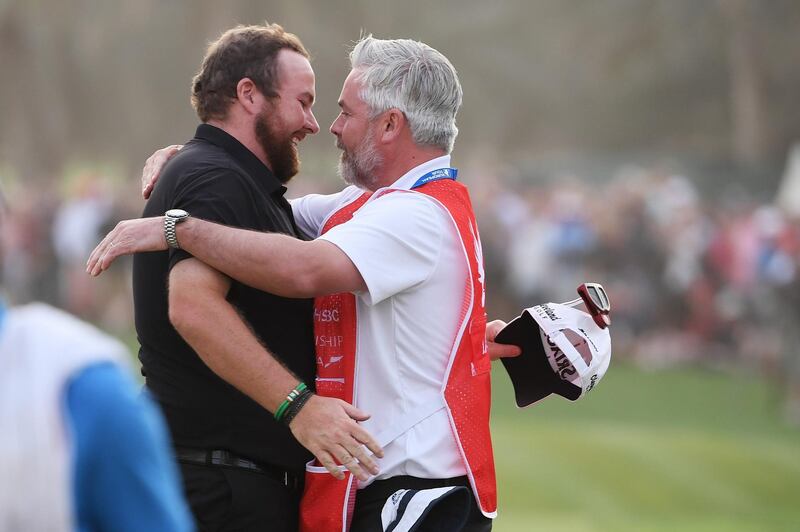 Lowry shares a celebration hug with his caddie Bo Martin after a thrilling final day in Abu Dhabi.