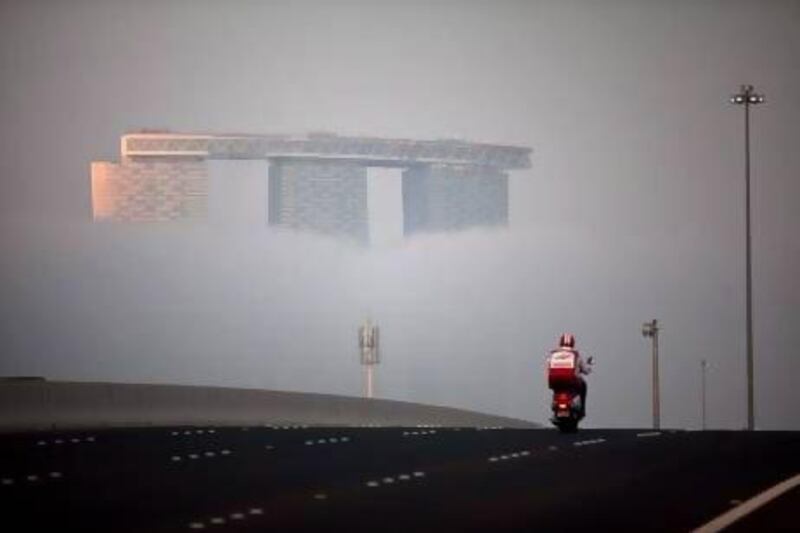 UAE motorists have been warned of more fog in the coming days. As with the rest of the city, a thick fog moved across the Abu Dhabi's Reem Island on Monday evening, Jan. 28, 2013. Silvia Razgova / The National