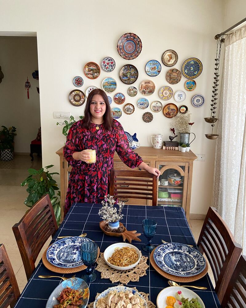 Keerat Kaur with her wall of souvenir plates from around the world. Photo: Keerat Kaur