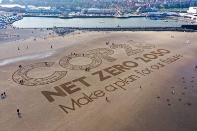 Britain is encouraging businesses to make ambitious climate plans before the Cop26 summit in Glasgow, as this sand artwork shows. Getty Images 