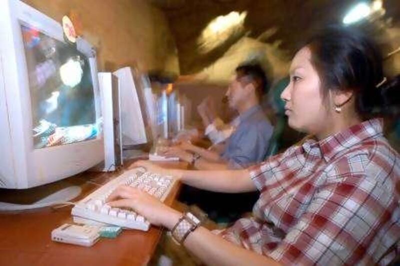 Kim You Mi, 23, plays the Internet game MU at a cyber cafe in Seoul  Friday, May 23, 2003. Webzen Inc. is the maker of a popular online monster-slaying fantasy game whose shares more than doubled in their trading debut. Photographer: Seokyong Lee/Bloomberg News