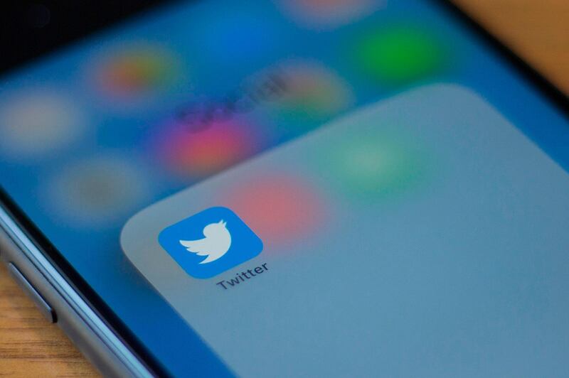(FILES) In this file photo taken on July 10, 2019 The Twitter logo is seen on a phone in this photo illustration in Washington, DC. Ireland has on December 15, 2020, fined Twitter 450,000 euros after the social media platform breached EU data privacy regulations, the country's data watchdog announced Tuesday. / AFP / Alastair Pike
