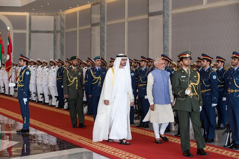 ABU DHABI, UNITED ARAB EMIRATES - August 16, 2015: HE Narendra Modi, Prime Minister of India (center R), inspects the UAE Armed Forces Honour Guard with HH Sheikh Mohamed bin Zayed Al Nahyan, Crown Prince of Abu Dhabi and Deputy Supreme Commander of the UAE Armed Forces, (center L), during a reception at the Presidential Airport. 
( Ryan Carter / Crown Prince Court - Abu Dhabi ) *** Local Caption ***  20150816RC_C066392.jpg