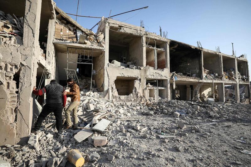 Men inspect the rubble of a hospital that was reportedly hit by an airstrike in the Syrian village of Shinan, about 30 kilometres south of Idlib in the northwestern Idlib province. AFP