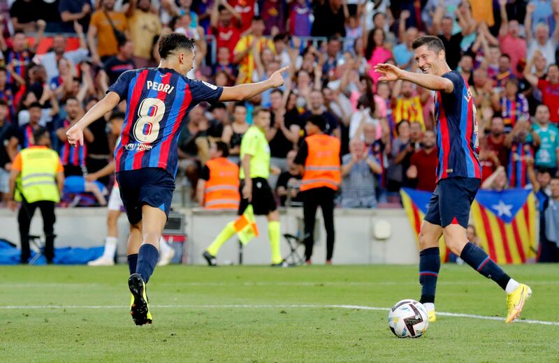 Pedri celebrates scoring Barcelona's second goal with Robert Lewandowski. Reuters