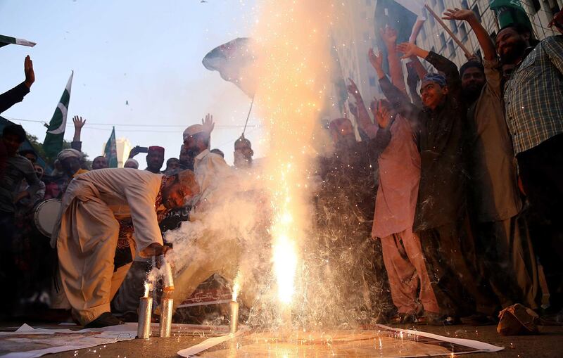 epa07401378 People celebrate after reports of Pakistani Air Forces shooting down India fighter jets, in Karachi, Pakistan, 27 February 2019. According to media reports, the Pakistan Army on 27 February 2019 stated it shot down two Indian fighter jets that were flying in its airspace. The incident came a day after India had claimed that its warplanes bombed a militant training camp and killed a large number of militants near the Line of Control (LoC) inside Pakistan.  EPA/SHAHZAIB AKBER