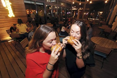 Customers at Bareburger in Dubai try its meat-free options. Chris Whiteoak / The National