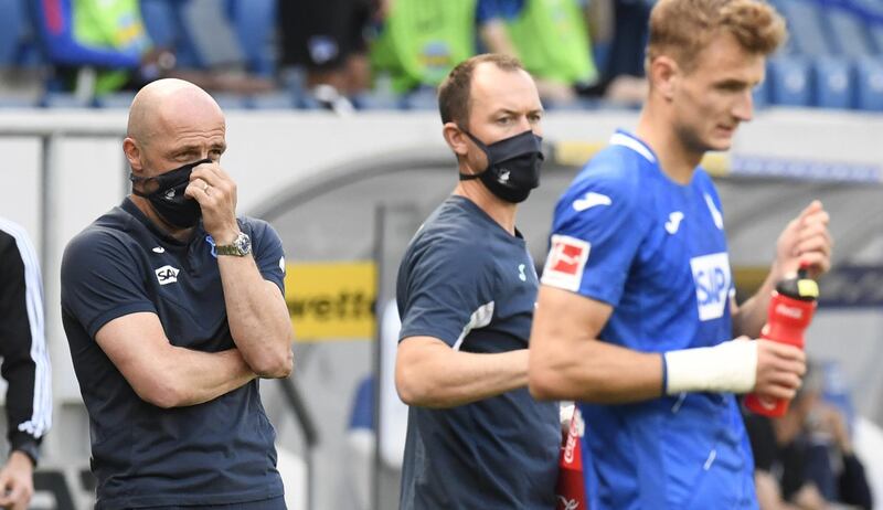 HOFFENHIEM 0 HERTHA BERLIN 3. Hoffenheim manager Alfred Schreuder, left, wearing a mask during the game. AP