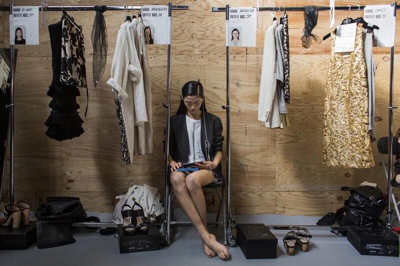 Qiwen Feng waits backstage prior to the presentation of the Dries Van Noten collection. Yoan Valat / EPA