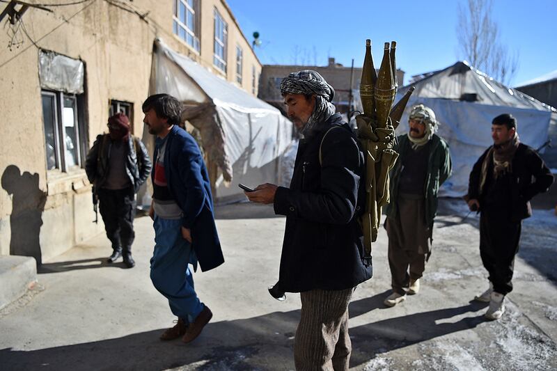 In this photo taken on January 9, 2021, Hazara armed militia for the Resistance for Justice Movement, stand inside of their base ahead to patrol against Taliban insurgents at Hisa-e-Awali Behsud district of Maidan Wardak Province. - Comprising roughly 10 to 20 percent of Afghanistan's 38-million population, Hazaras have long been persecuted for their largely Shiite faith by Sunni hardliners in a country wracked by deep ethnic divisions. (Photo by WAKIL KOHSAR / AFP) / TO GO WITH'Afghanistan-Hazara-violence', by David STOUT, Najiba NOORI