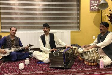 Shafiq Baksh, centre, performs with Ahmad Wali, left, and Zulgai Nabizada at a private event in Kabul after iftar on May 29, 2019. Hikmat Noori for The National