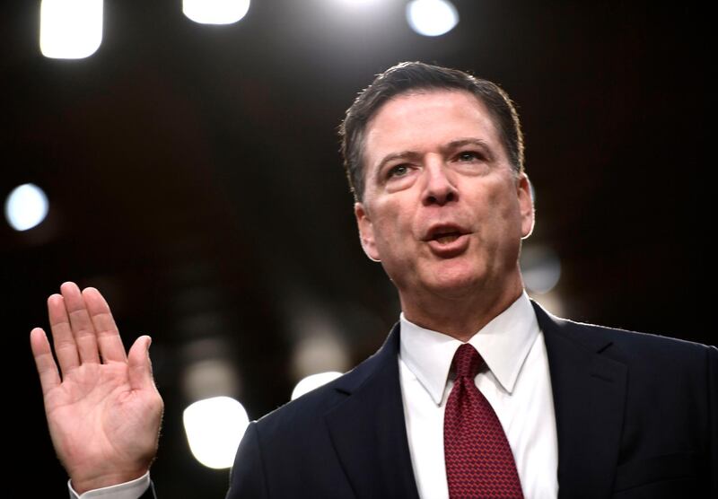 (FILES) In this file photo taken on June 8, 2017, Former FBI Director James Comey takes the oath before he testifies during a US Senate Select Committee on Intelligence hearing on Capitol Hill in Washington, DC.
Former FBI director James Comey says in a new book that President Donald Trump reminded him of a mafia boss who demanded absolute loyalty, saw the entire world against him, and lied about everything. According to excerpts of the book leaked by US media on April 12, 2018, Trump was also obsessed with the alleged existence of a video in which Russian prostitutes said to be hired by Trump urinated on the bed in a Moscow hotel room. / AFP PHOTO / Brendan Smialowski