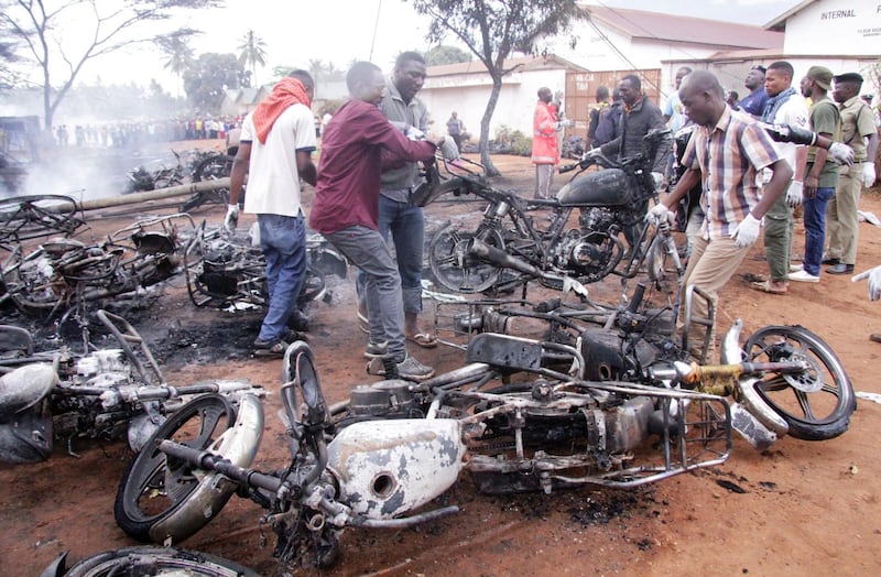 Rescuers remove burnt motorbikes from the scene where a fuel tanker exploded killing a crowd of people collecting liquid from puddles in jerry cans in Morogoro, eastern Tanzania August 10, 2019. REUTERS/Emmanuel Herman NO RESALES. NO ARCHIVES