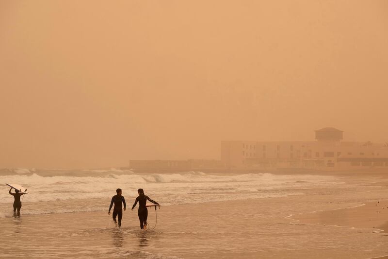Surfers go for a swim at Playa Blanca in Puerto del Rosario, Fuerteventura, Canary Islands.  EPA