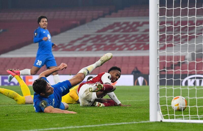 Molde's Kristoffer Haugen scores an own goal and the first for Arsenal under pressure from Joe Willock. Reuters