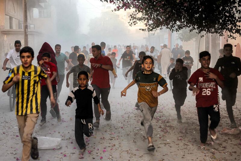 Palestinian children run from Israeli bombardment in Rafah, in the southern Gaza Strip. AFP