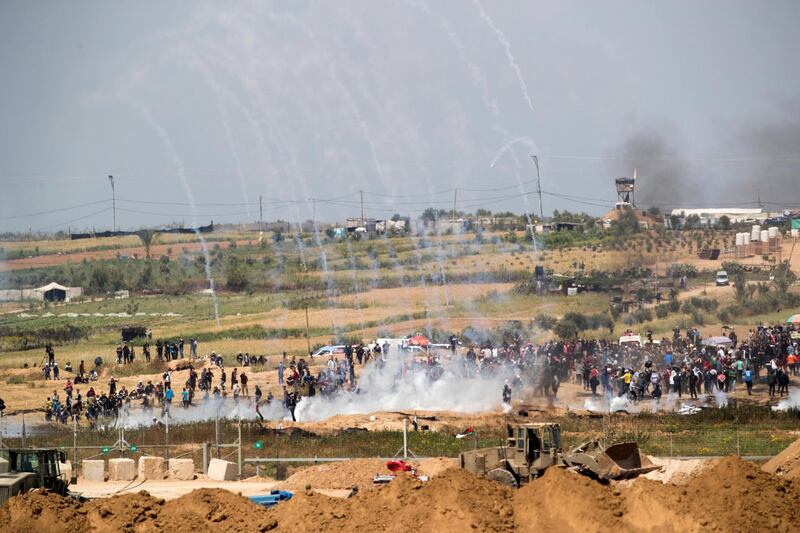 Tear gas canisters fired by Israeli forces fall on a 2018 Palestinian protest march. EPA