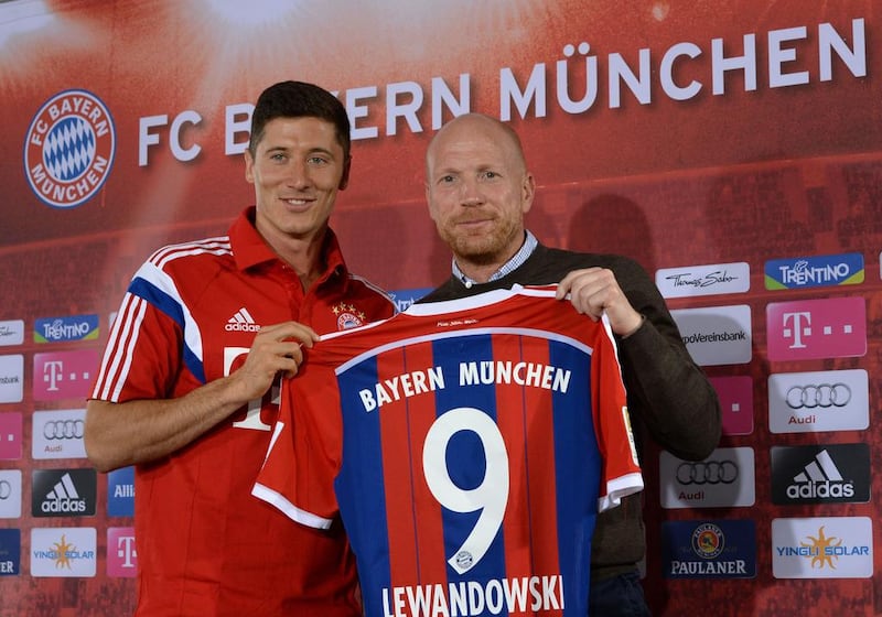 Bayern Munich's new Polish striker Robert Lewandowski and Bayern Munich sports director Matthias Sammer present Lewandowski's new shirt at Bayern Munich's training grounds on Wednesday in Munich, Germany. Christof Stache / AFP