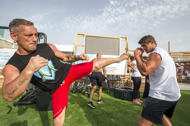 DUBAI, UNITED ARAB EMIRATES, 28 APRIL 2018 - Michele Vergineli (left) practicing his moves at Magnum Fitness open day at Kite Beach, Jumeirah Beach Road, Dubai. Leslie Pableo for The National for Haneen Dajani's story