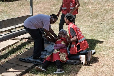 Kenya Red Cross staff assist a grieving woman at the Chiromo Mortuary in Nairobi on January 17, 2019. AFP