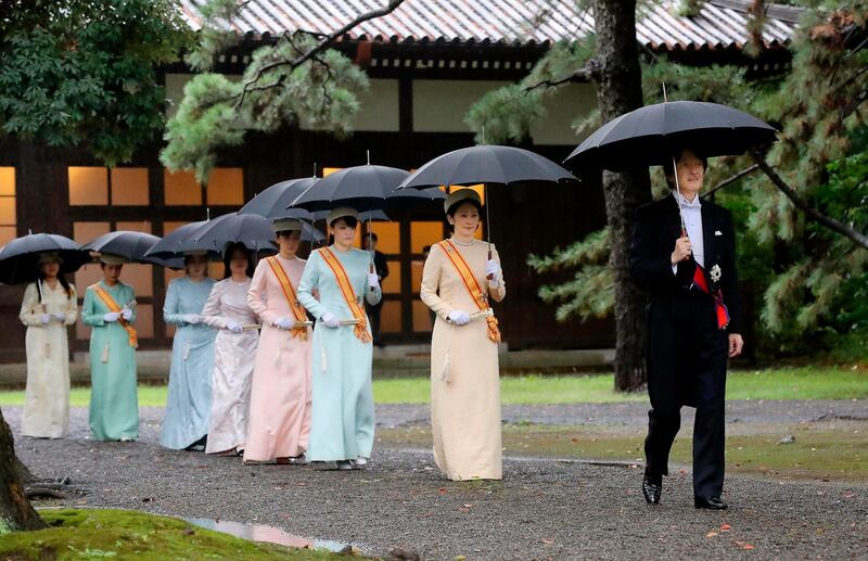 Japan's Crown Prince Akishino, right, and Crown Princess Kiko, second from right, arrive for the ceremony at "Kashikodokoro", one of three shrines at the Imperial Palace, in Tokyo, Tuesday, Oct. 22, 2019. AP