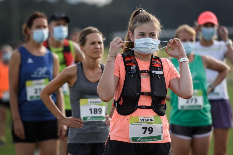 Runners line up prior to the start of the "Tour du Pays de Vaud" running stage race organised with health measures amid the Covid-19 outbreak in Champvent, Switzerland. AFP