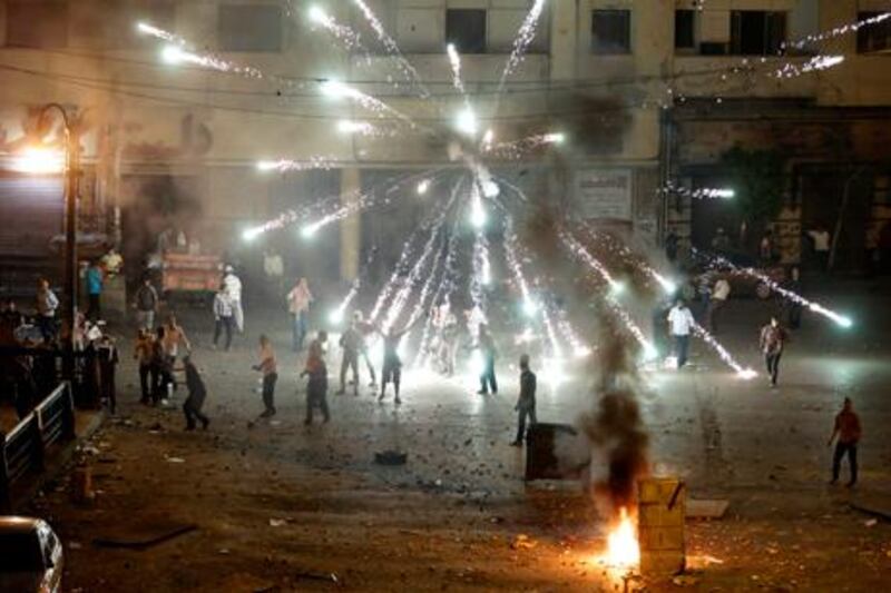 A firework fired by opponents of ousted President Mohammed Morsi explodes over the supporters during clashes in downtown Cairo last night. AP Photo/Hussein Malla