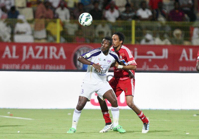 Dubai, United Arab Emirates, Sep 17, 2012 -  Asamoah Gyan (3) ,left, from  Al Ain fight for the ball  against Juma Abdulla from Al Jazira during the  Super Cup final match at Al Wasl Sports Club.  ( Jaime Puebla / The National Newspaper )