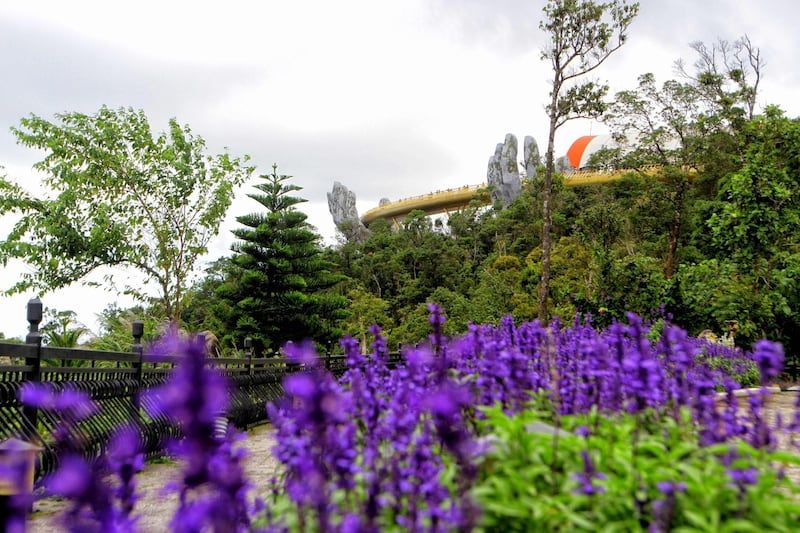 The Golden Bridge is seen past flowers and a line of trees. AFP Photo