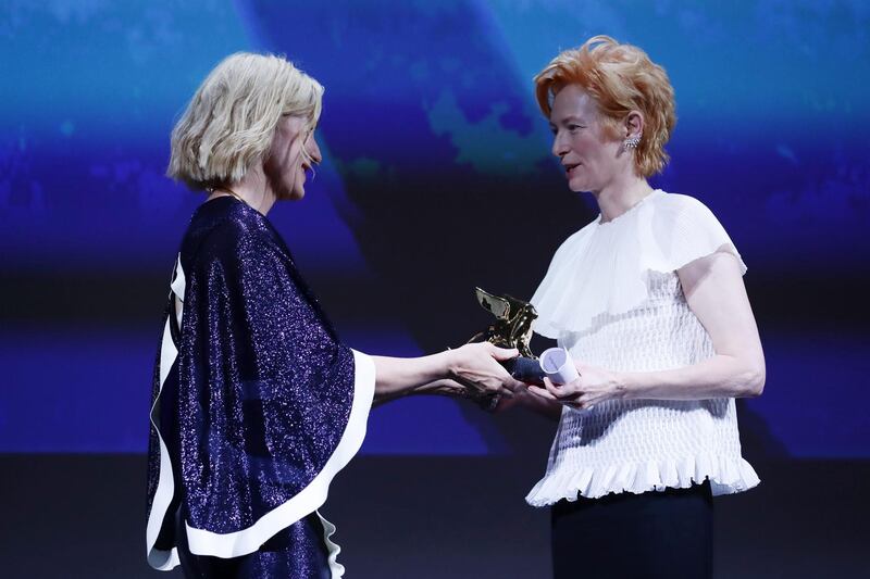 Tilda Swinton is presented with the Golden Lion Lifetime Award by Cate Blanchett during the Opening Ceremony. Getty Images