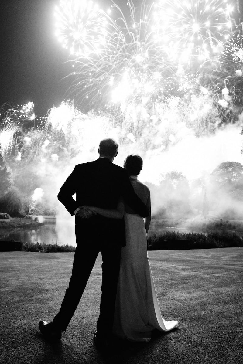This photo released by Kensington Palace, shows the photo taken by Chris Allerton of Britain's Prince Harry and Meghan, Duchess of Sussex at their wedding reception at Frogmore House, Windsor, England, which is to be used as their 2018 Christmas card.  AP