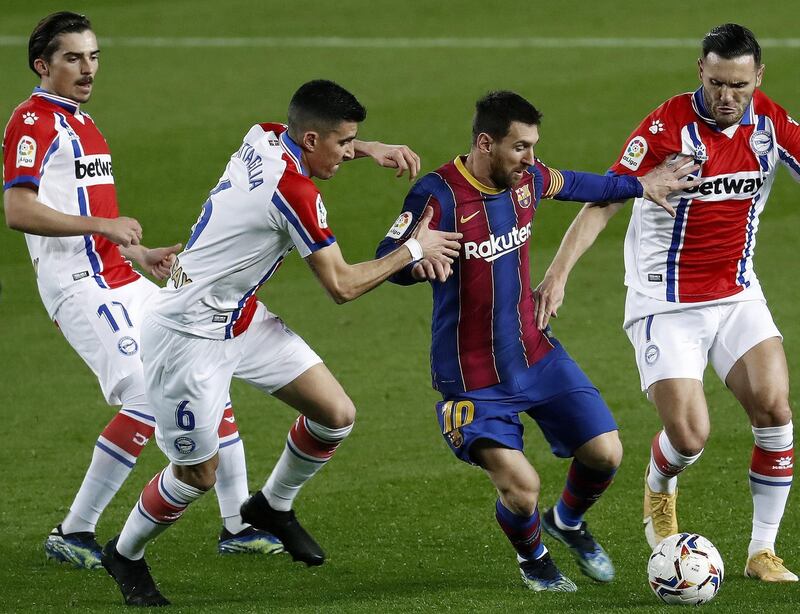 Barca's Lionel Messi is surrounded by Alaves players. EPA