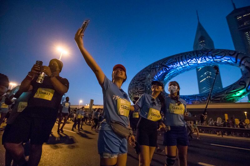 Participants take selfies in front of the Museum of the Future