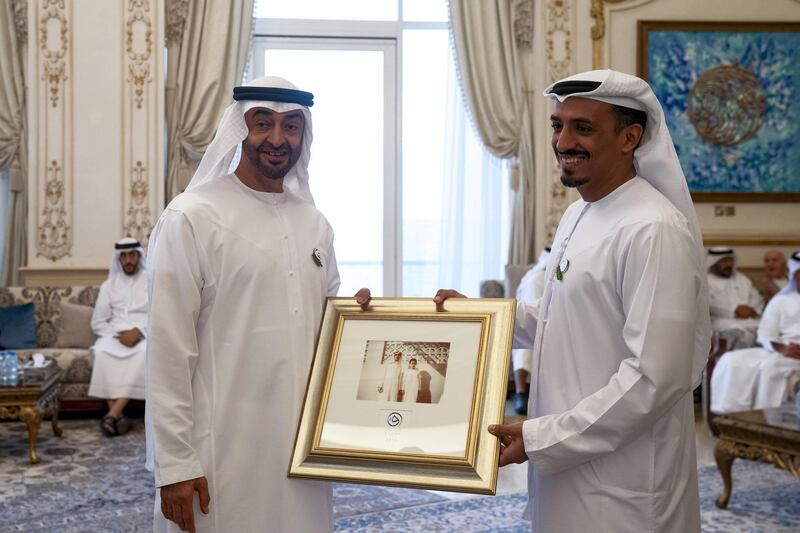 ABU DHABI, UNITED ARAB EMIRATES - October 07, 2019: HH Sheikh Mohamed bin Zayed Al Nahyan, Crown Prince of Abu Dhabi and Deputy Supreme Commander of the UAE Armed Forces (L) receives a photograph of his former teacher Ahmed Ibrahim Al Tamimi from Mohamed Al Nuaimi, Director of Education at Crown Prince Court and director of the Qudwa Forum (R), during a Sea Palace barza. 

( Mohamed Al Hammadi / Ministry of Presidential Affairs )
---